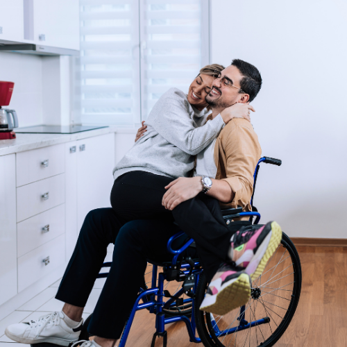 Couple embracing, one partner in a wheelchair